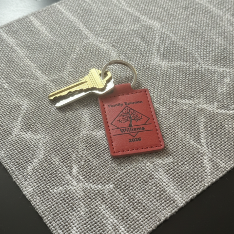 Red leather keychain with Family Reunion and year with tree inside slanted square and split for family name